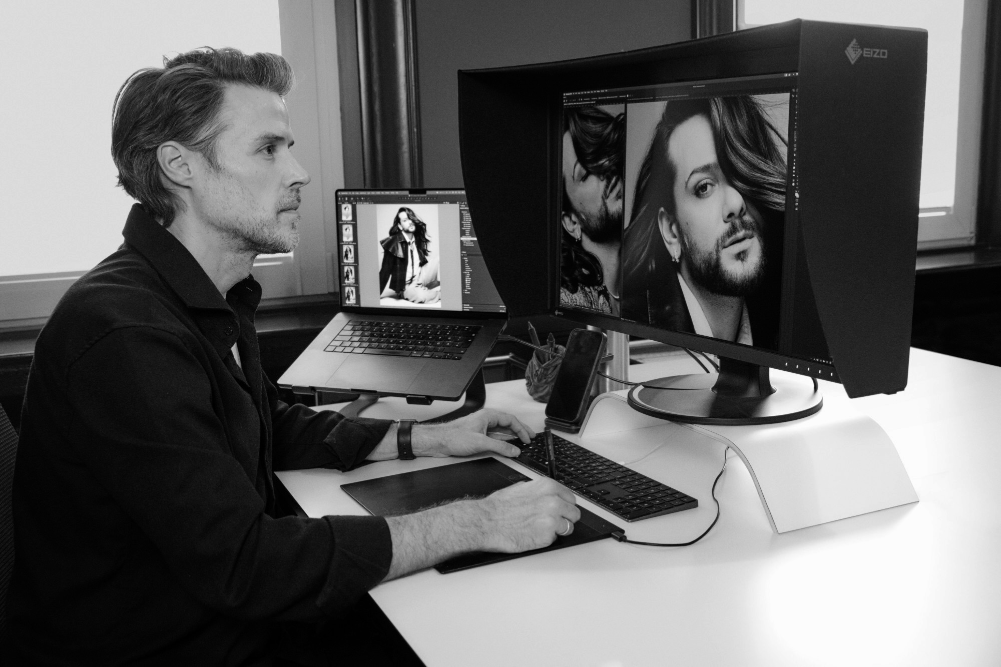Jan Wischermann retouching at his desk with an Eizo monitor and a Wacom tablet